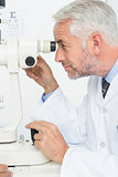 Senior optician in examination room