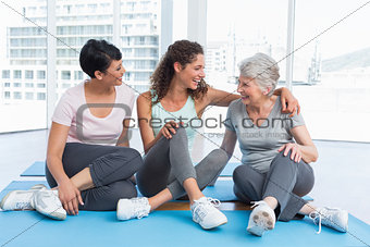 Full length of cheerful women in yoga class