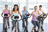 Happy women working out at spinning class