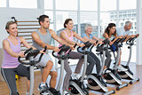 Happy people working out at spinning class
