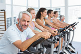People working out at spinning class in gym
