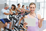 Female trainer with people working out at spinning class