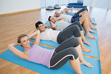 Class lying on mats in row at yoga class