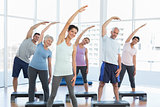 Class stretching hands in yoga class