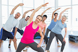 Class stretching hands at yoga class