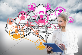 Blonde businesswoman using tablet pc with cloud computing graphic