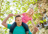 Cute Young Girl Rides Piggyback On Her Dads Shoulders