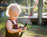 Cute Young Boy With Fishing Pole at The Lake
