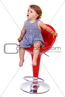 Little toddler girl on red bar stool