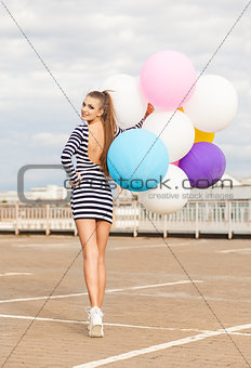 beautiful lady in short black and white striped dress holds bunc