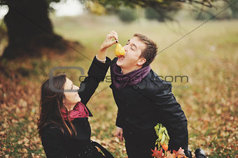 Young sweet couple having date in autumn park.
