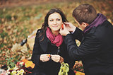 Young couple having fun in autumn park.