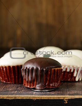 sweet cupcakes with chocolate icing white and black