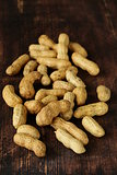 natural whole peanuts on wooden brown board