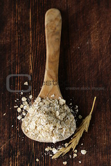 organic oat flakes in a wooden spoon