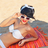 a beautiful young girl in retro look with red lips in a white sw