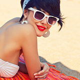 a beautiful young girl in retro look with red lips in a white sw
