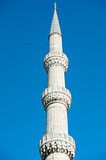 Minaret against blue sky background