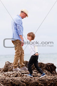 father and son playing outdoor on beach summer vacation
