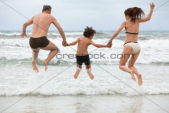 happy family ith two boys having fun in water summer holiday