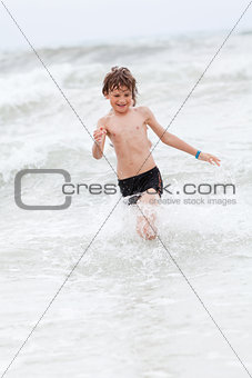 young little boy in water summer holiday fun sea 