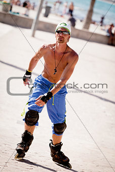 young man with inline skates in summer outdoor 