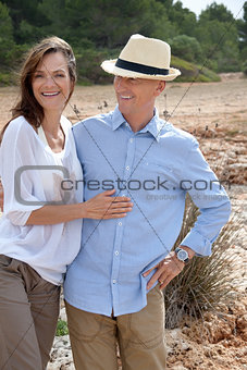 happy adult couple in summertime on beach 