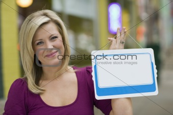 Woman with blank white sign for text