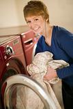 Woman taking laundry out of dryer