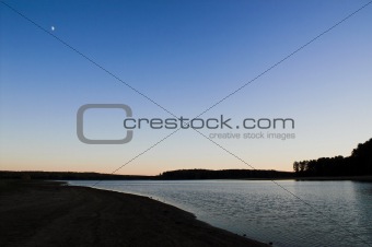 Sunset Moon over a Lake