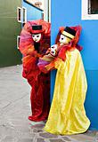 Two clowns in mask performing