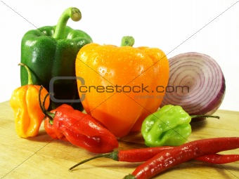 peppers in a pile on a cutting board