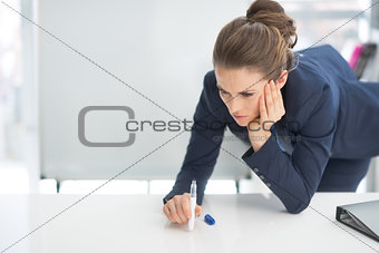 Stressed business woman near flipchart