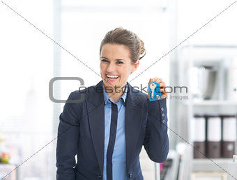 Happy business woman showing keys