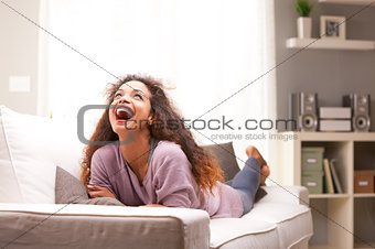 beautiful young black happy woman on a sofa