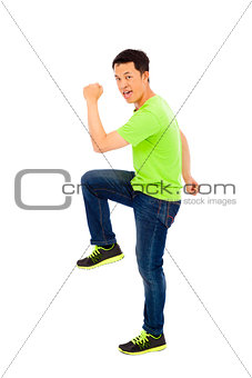 Young happy man raise hand and leg