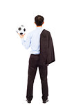 Back view of young business man with soccer ball