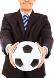 smiling businessman show a soccer