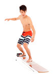 young  surfer simulate surfing pose