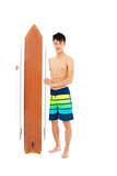 young man holding a surfboard 