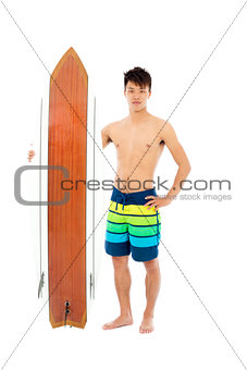 smiling surfer holding a surfboard