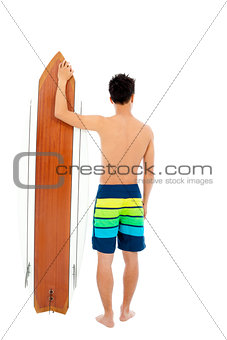 young man holding a surfboard  and looking forward 