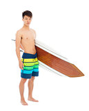 young boy holding a surfboard over white background