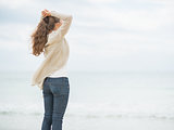 Young woman on cold beach looking into distance