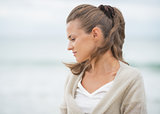 Portrait of relaxed young woman on cold beach