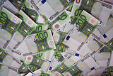 background from chaotically lyings one hundred euro banknotes