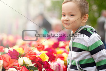 Little Boy With Easter Eggs And Flowers