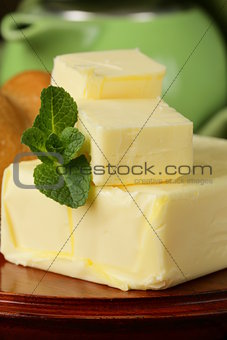 piece of fresh butter for breakfast on a wooden board