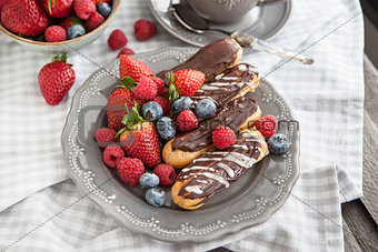 Chocolate eclairs with fresh berries