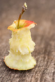 apple that has been eaten, on old wooden table